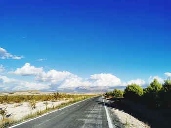 Empty road along countryside landscape