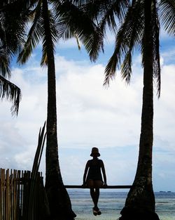 Silhouette of woman walking on road