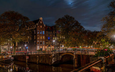 Illuminated buildings against sky at night