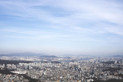 Aerial view of illuminated cityscape against sky