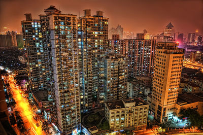 Illuminated modern buildings in city at night