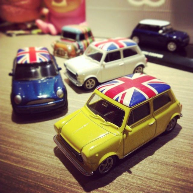 still life, indoors, toy, focus on foreground, close-up, table, selective focus, transportation, childhood, land vehicle, no people, multi colored, wood - material, mode of transport, metal, single object, stationary, man made object, high angle view, equipment