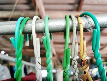 Close-up of clothespins hanging on clothesline