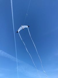 Low angle view of airplane flying against blue sky