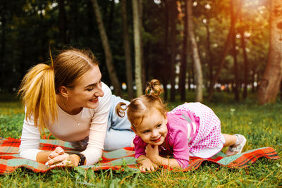 Happy harmonious family outdoors. young mother and daughter spend joint activities on holidays.