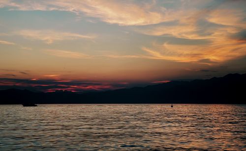 Scenic view of sea against romantic sky at sunset