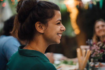 Portrait of a smiling young woman looking away