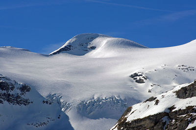 Scenic view of snow covered mountains against clear sky