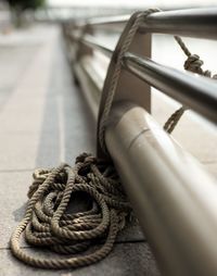 Close-up of rope tied on metal railing