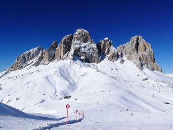 Scenic view of snowcapped mountain against clear blue sky