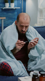 Low section of man sitting at home