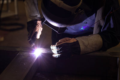 Manual worker welding in factory