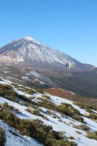 Scenic view of snowcapped mountains against clear blue sky