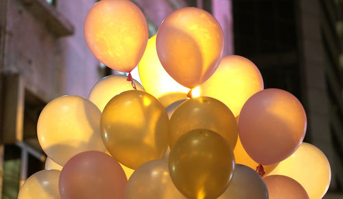 Low angle view of balloons at night