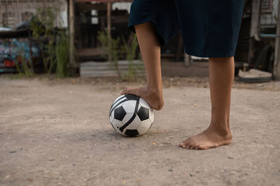 Low section of boy playing with ball