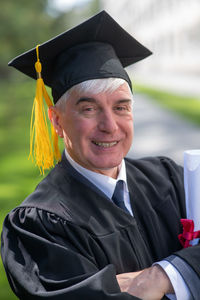 Portrait of man wearing graduation gown