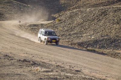 Car on dirt road on land