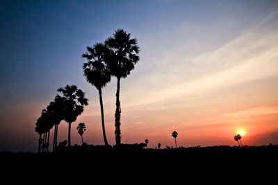 Silhouette trees against sky during sunset