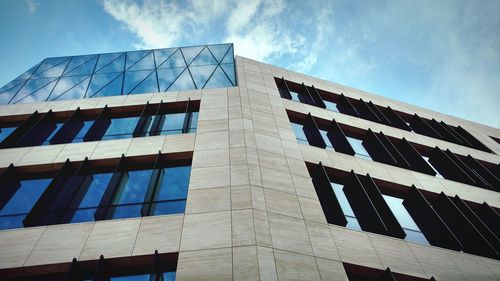 Low angle view of office building against sky