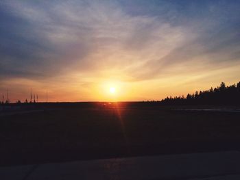 View of calm countryside landscape at sunset