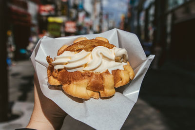 Close-up of hand holding ice cream