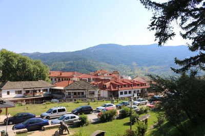 High angle view of buildings and trees against clear sky