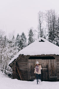  view of woman standing on snow covered landscape