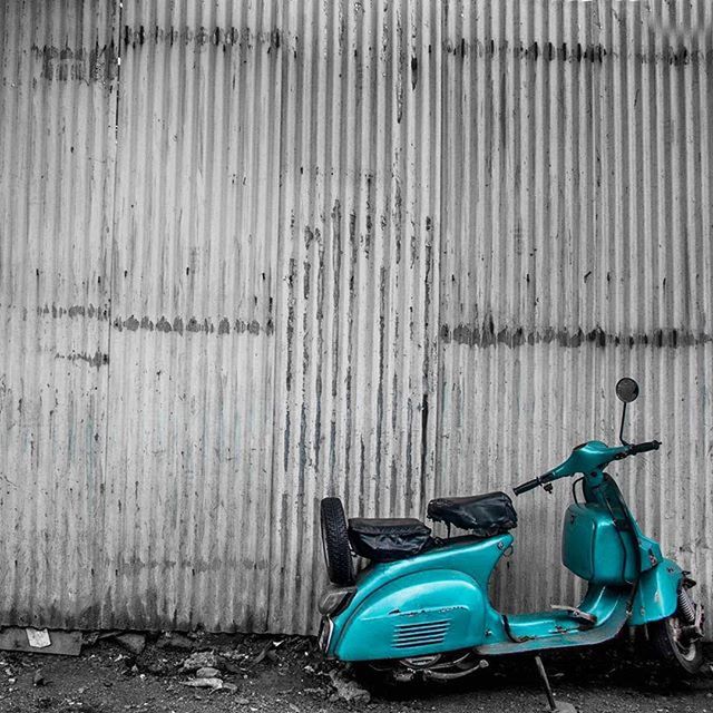 transportation, blue, mode of transport, metal, stationary, absence, wall - building feature, land vehicle, day, no people, outdoors, bicycle, empty, parked, abandoned, parking, built structure, protection, in a row, still life