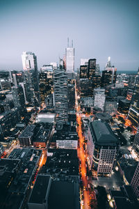 Illuminated cityscape against sky