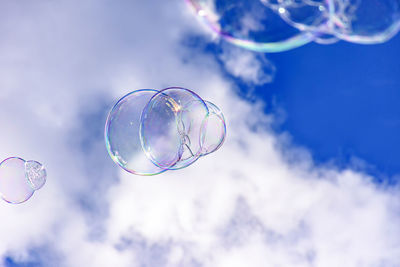 Low angle view of bubbles against sky