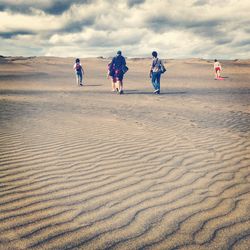 Tourists walking on beach