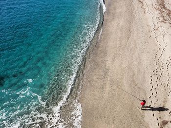 High angle view of man fishing at beach