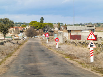 Road sign against sky