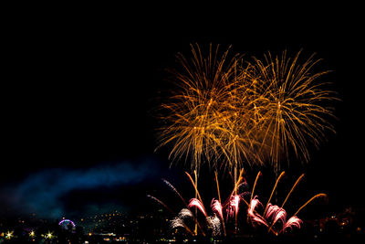 Low angle view of firework display at night