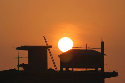 Silhouette of building against sky during sunset