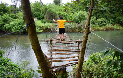 Rear view of woman standing in lake