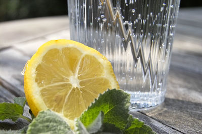 Close-up of lemon slice on glass table