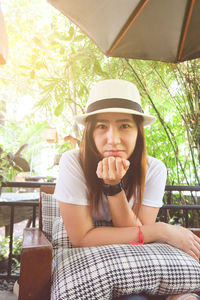 Portrait of young woman sitting in restaurant