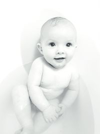 Portrait of cute baby girl in bathtub at home