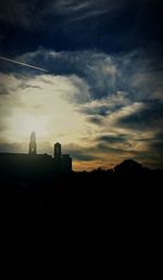 Silhouette of building against cloudy sky