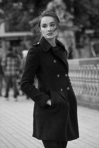 Portrait of young woman standing outdoors