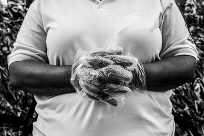 A person with plastic gloves on his hands. 