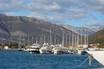 Sailboats moored in sea against sky