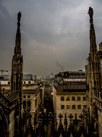 High angle view of cityscape against cloudy sky seen from milan cathedral