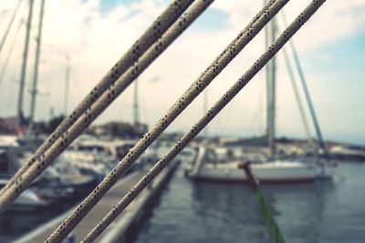 Close-up of suspension bridge against sky