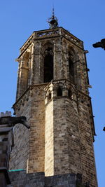 Low angle view of bell tower against sky