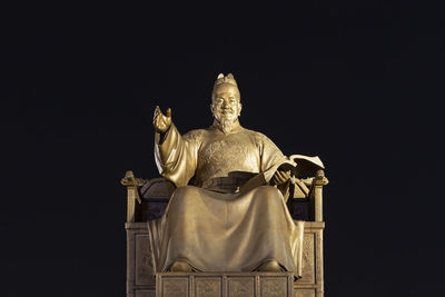 Low angle view of statue against sky