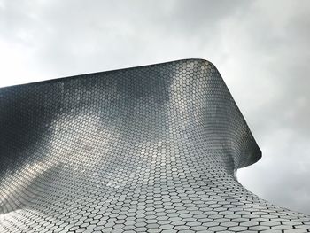 Low angle view of building against cloudy sky