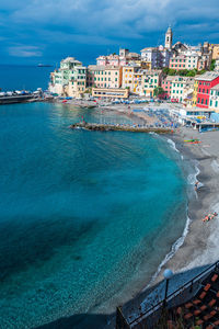 Scenic view of sea against buildings in city