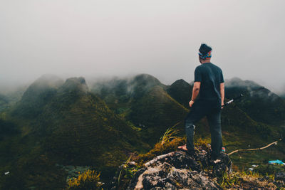 Rear view of man looking at mountains